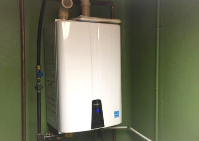 new tankless water heater installed in laundry room